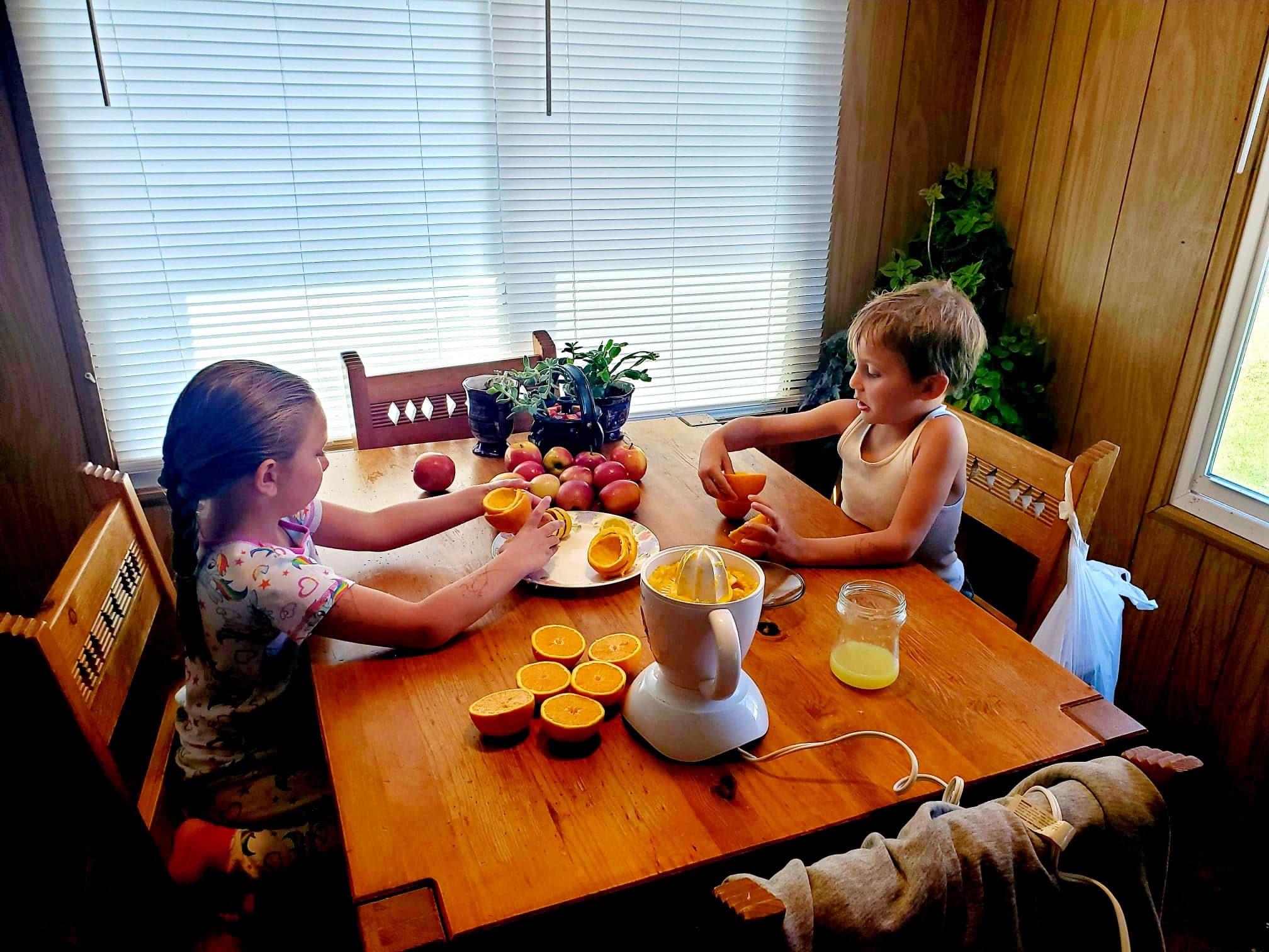 Siblings Juicing Oranges